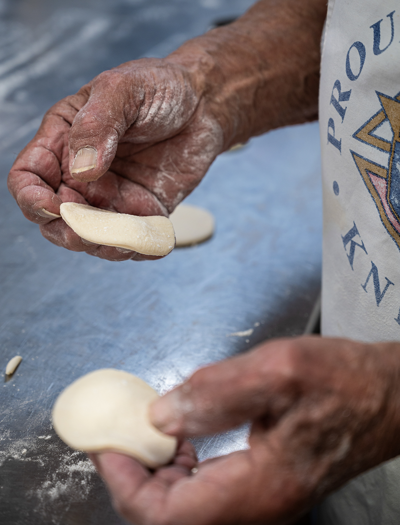 https://www.avenuecalgary.com/wp-content/uploads/2022/10/Jim-Ochitwa-punches-out-dough-circles.jpg