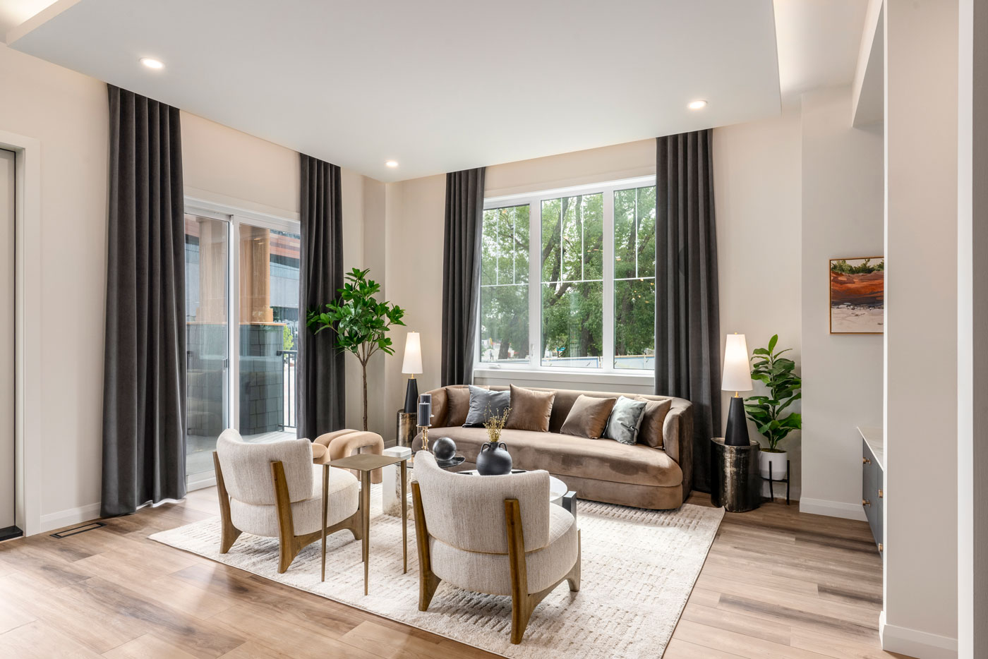 A living room with a sofa and chairs