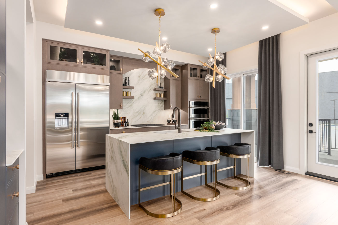 A kitchen with bar seating at the island