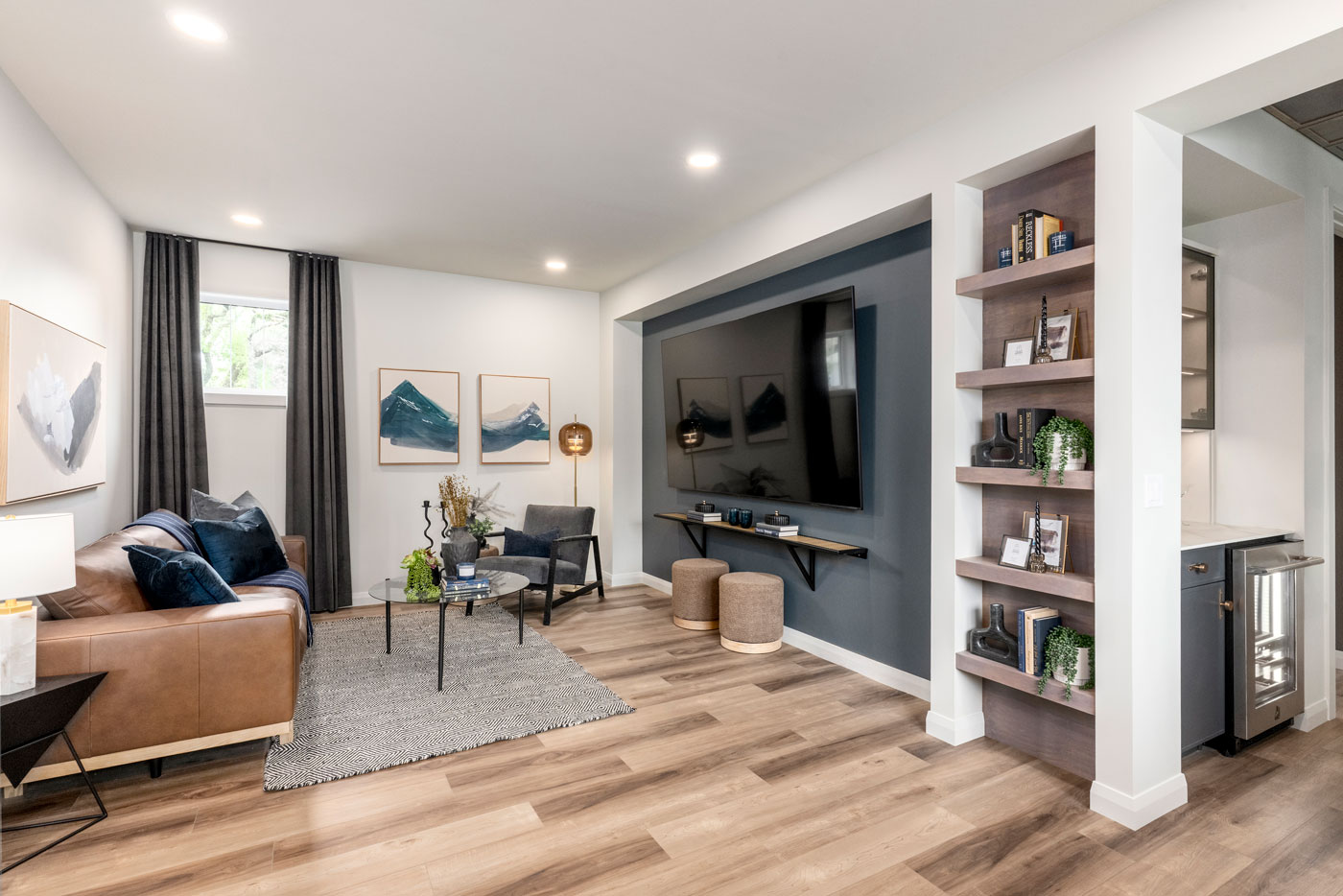 An upstairs bonus room with a seating and a TV
