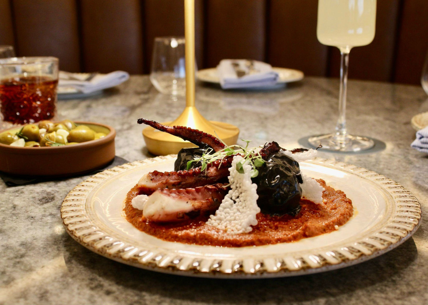 A grilled octopus dish on a restaurant table