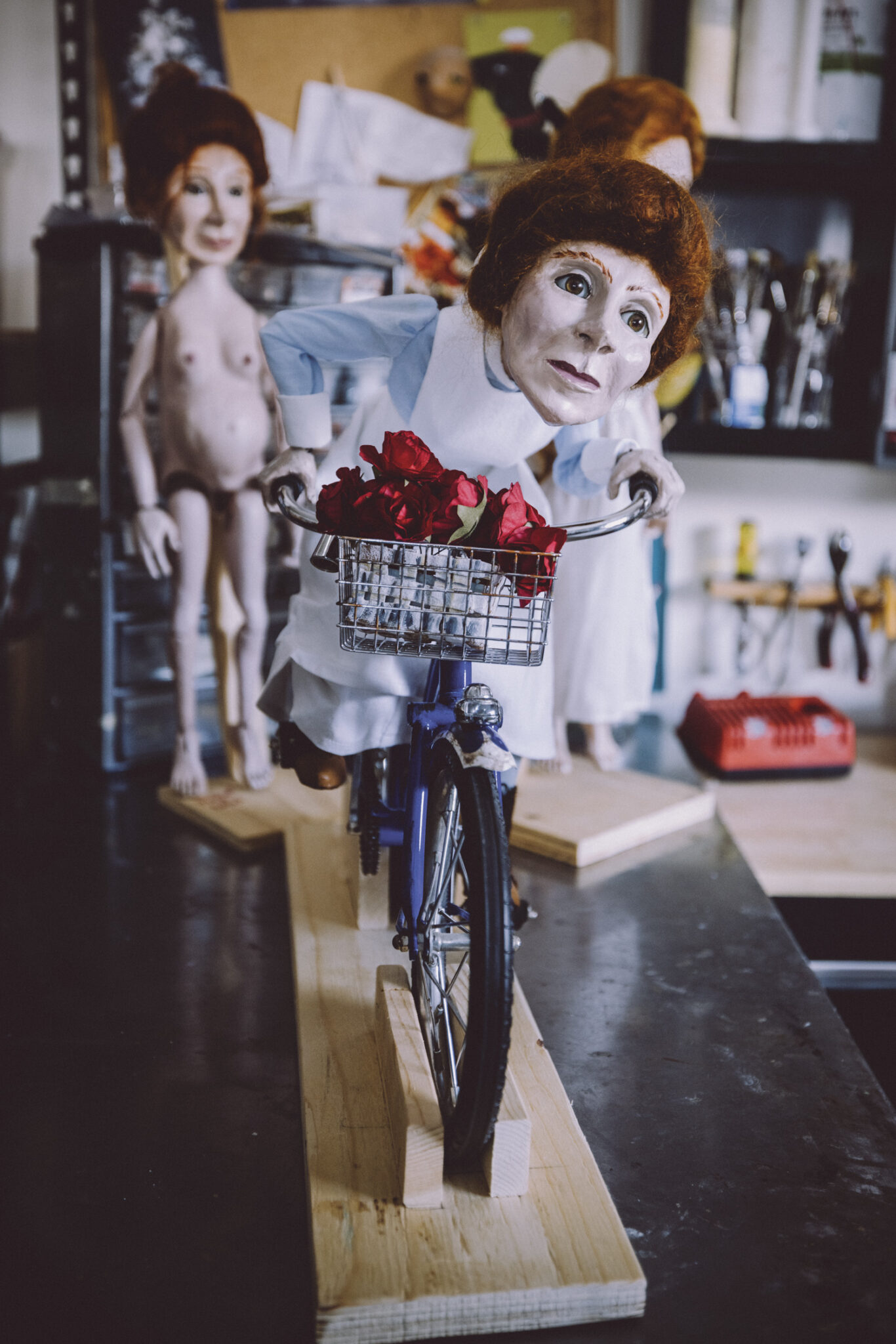 A puppet riding a bicycle.