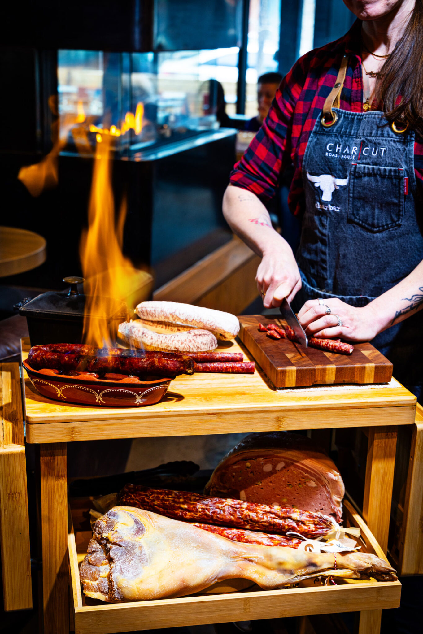 Connie De Sousa slices house-made charcuterie.