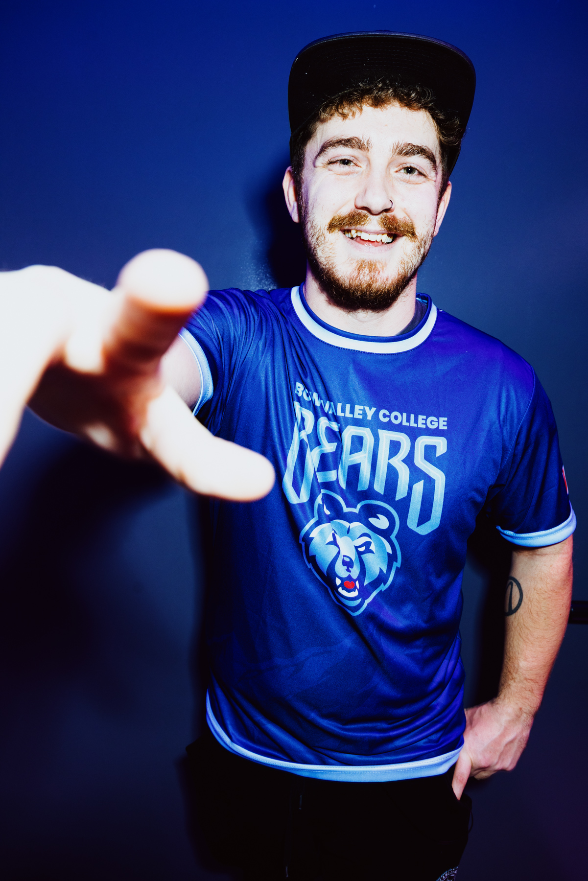 A person wearing a Bow Valley College Bears shirt.