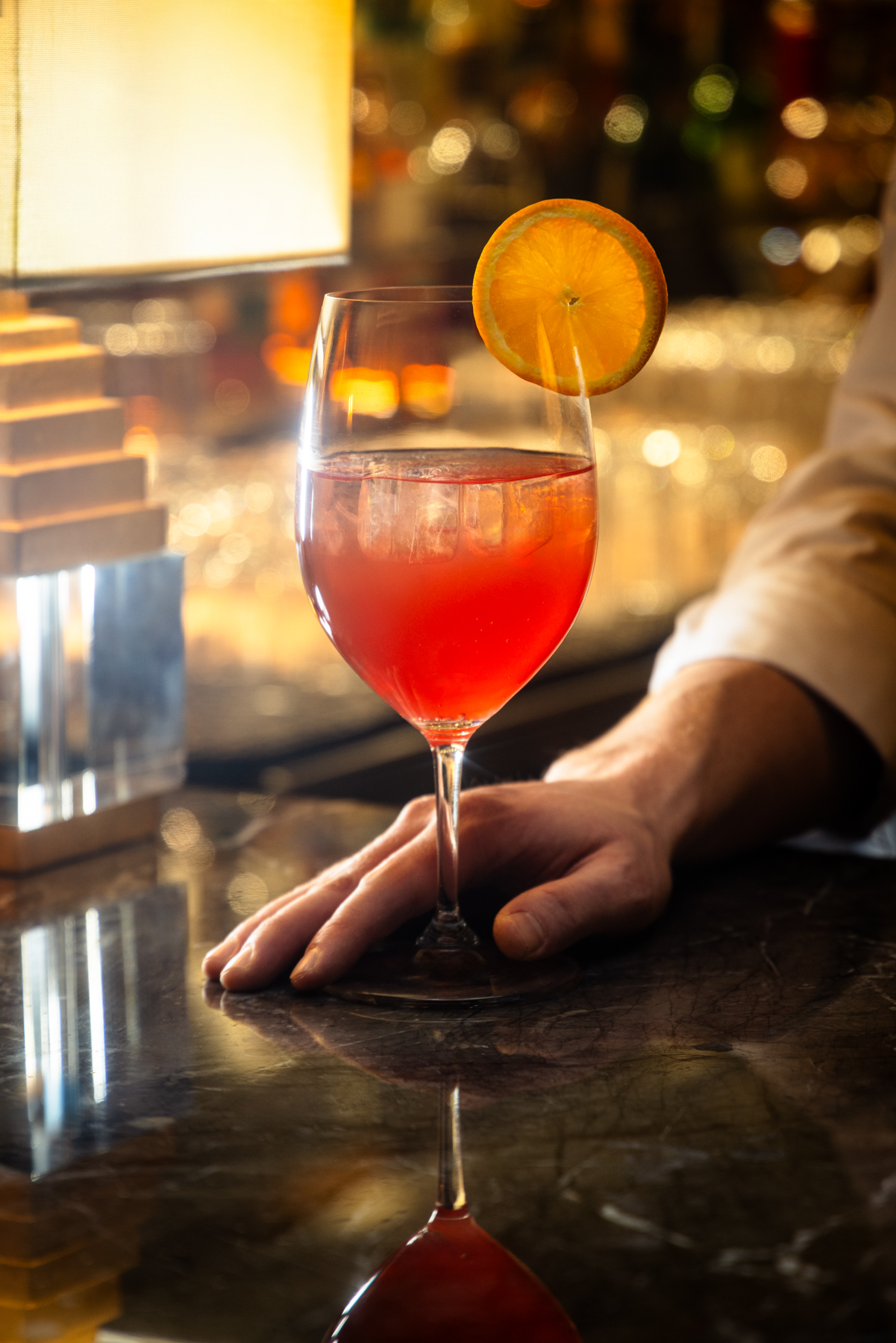 A hand holds a non-alcoholic beverage. 