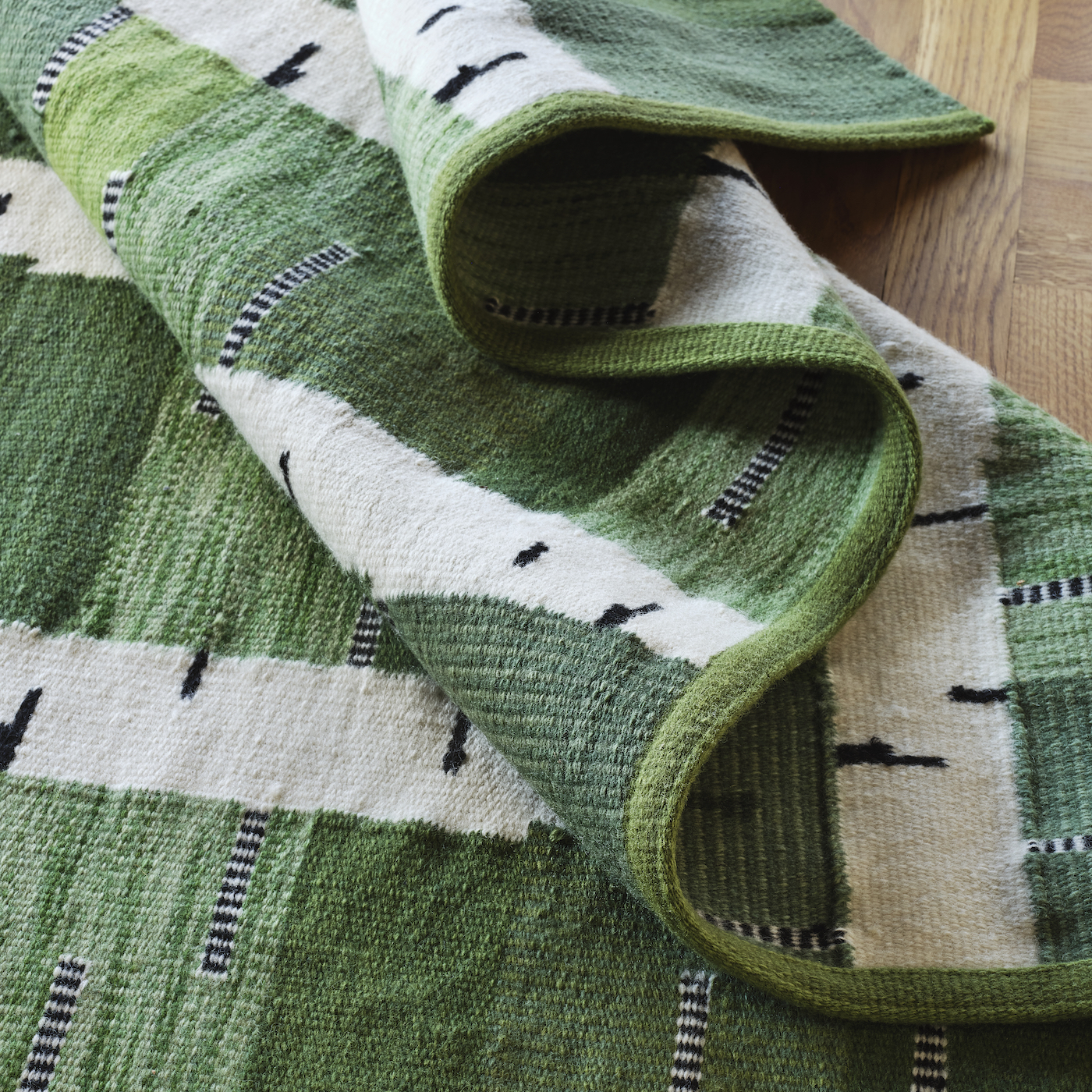 A green, black and white rug