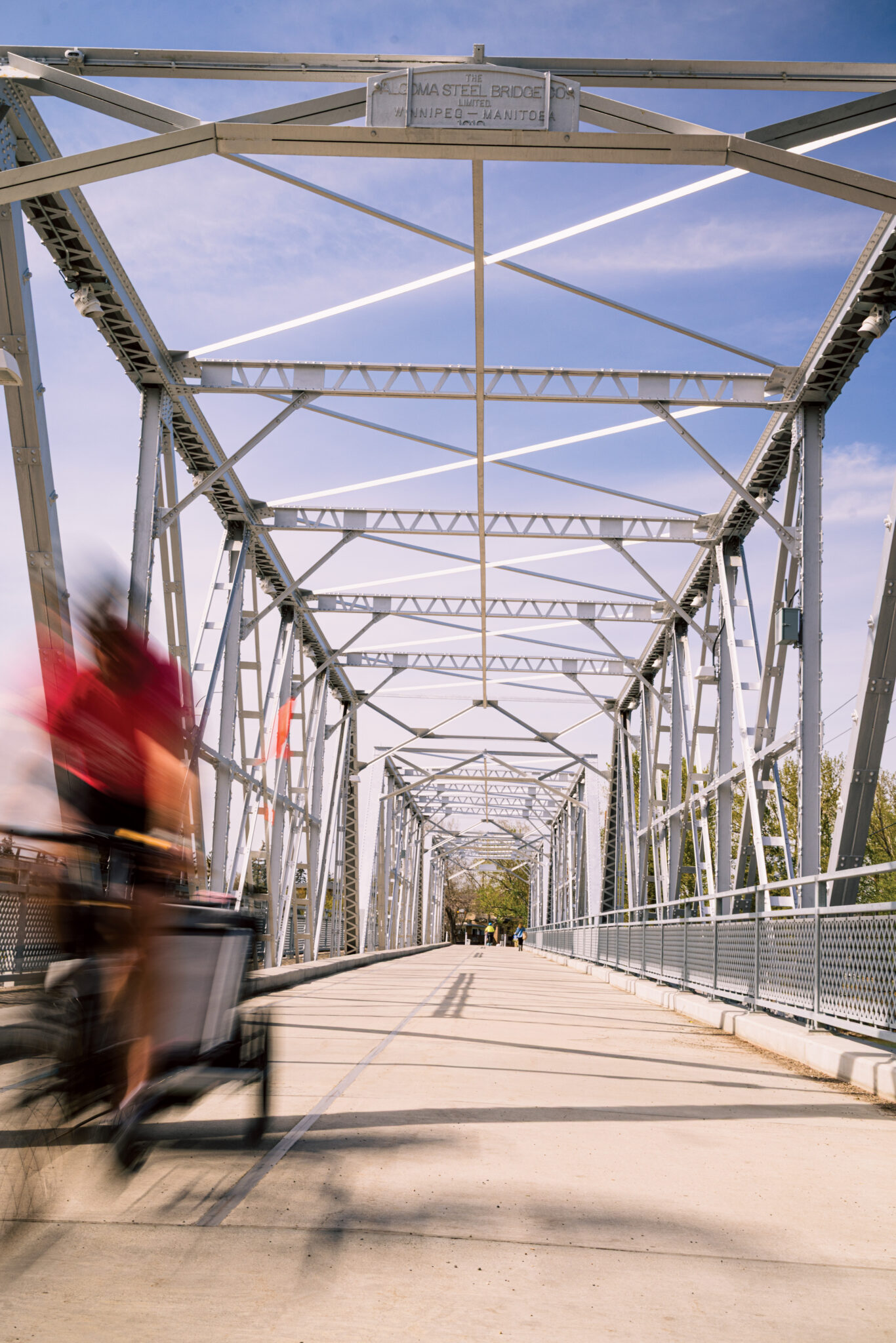 A cyclist speeds past on a bridge in Bowness.