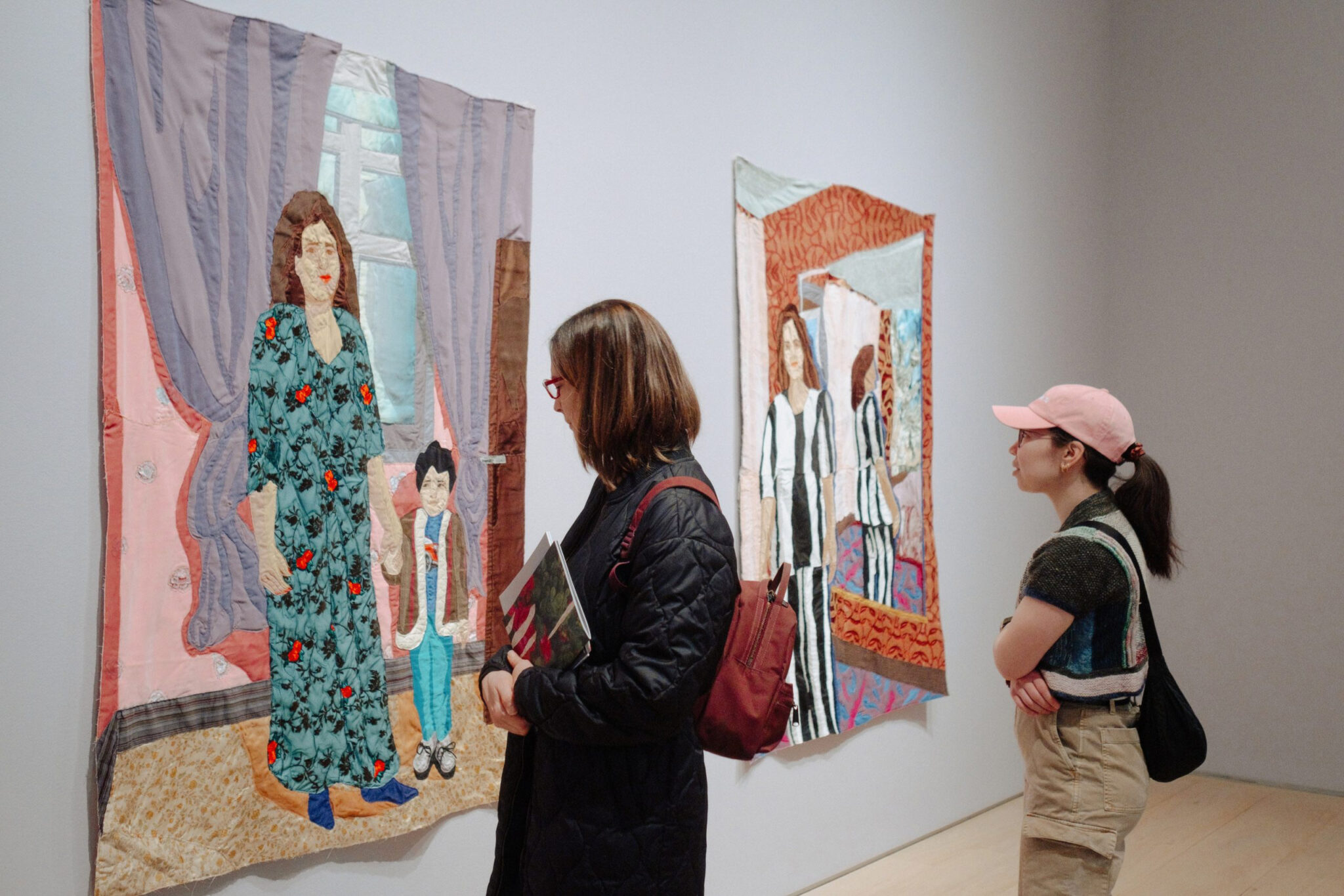 People look at a gallery exhibition.