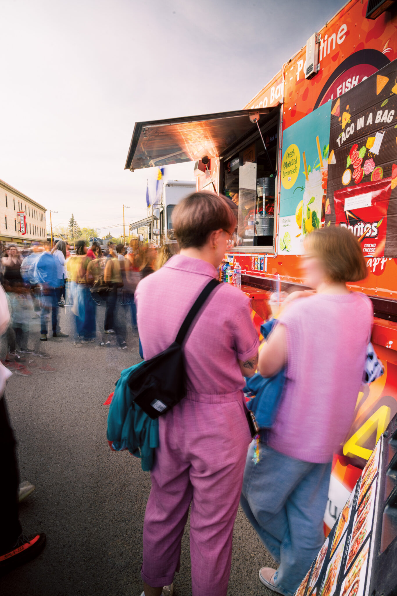 Two people stand beside a food truck in Inglewood.