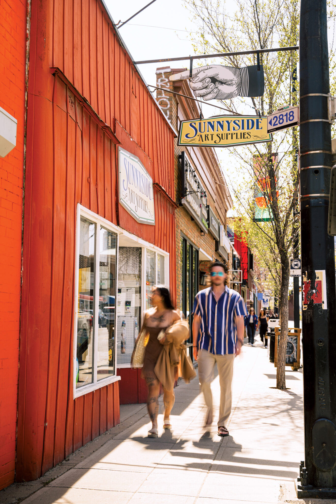 Two people walk by an art supply store in Kensington.