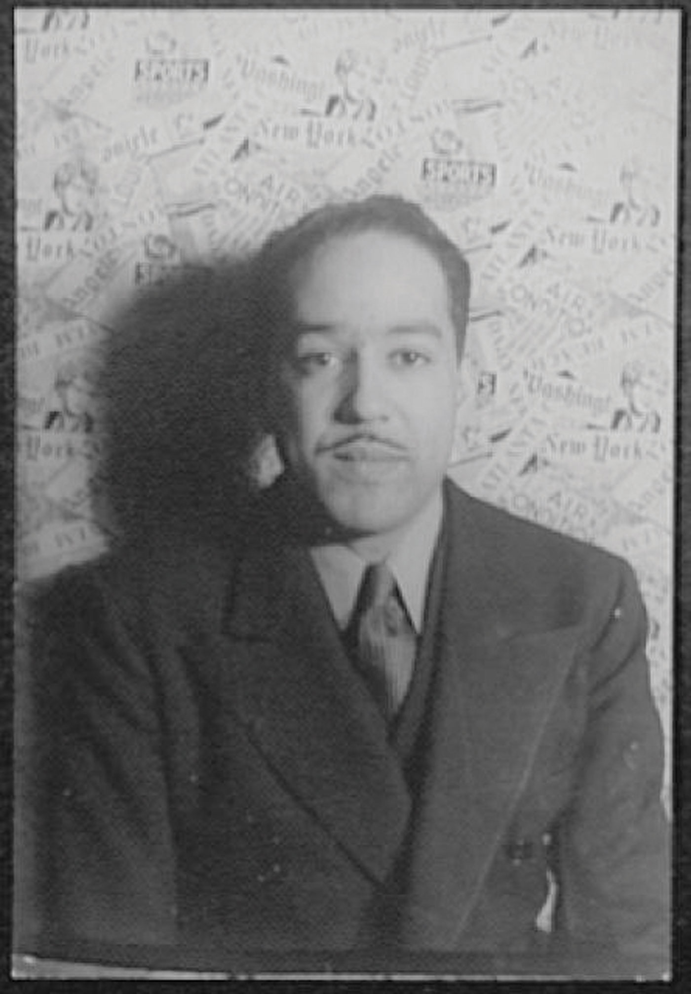A black and white photo of Langston Hughes.