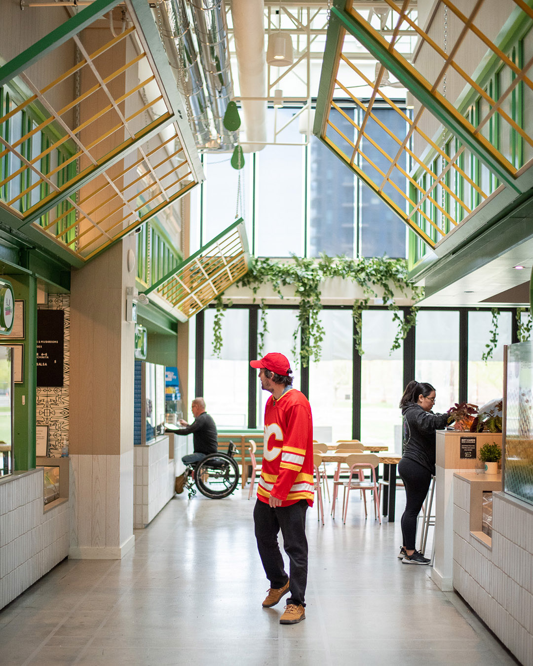 A man walks through the hallway of a food hall.