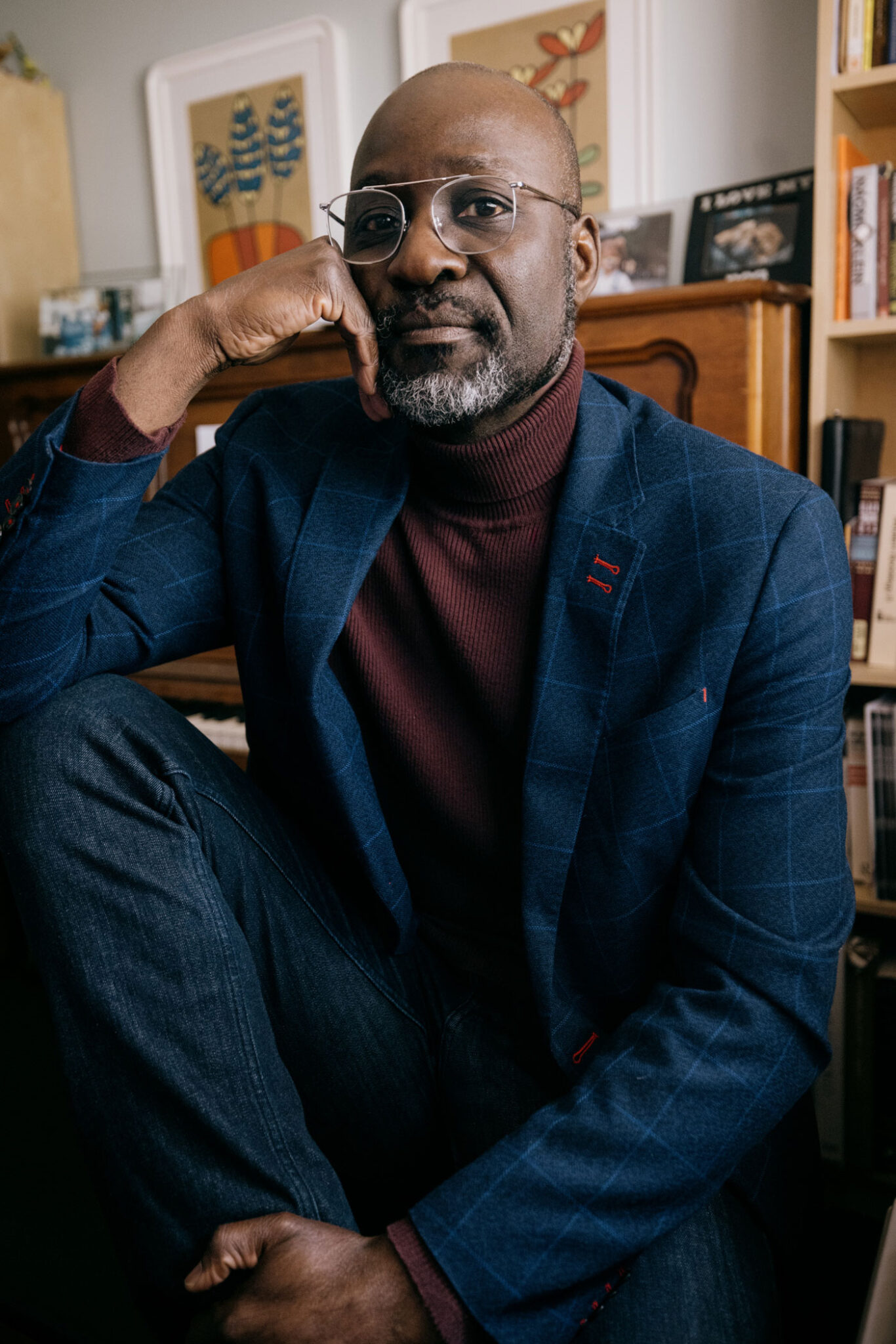 Bertrand Bickersteth in a blue suit and red turtleneck
