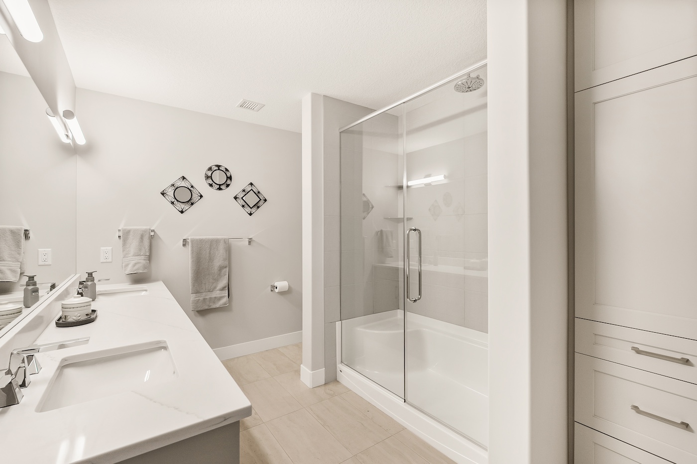 A bathroom with white, neutral decor