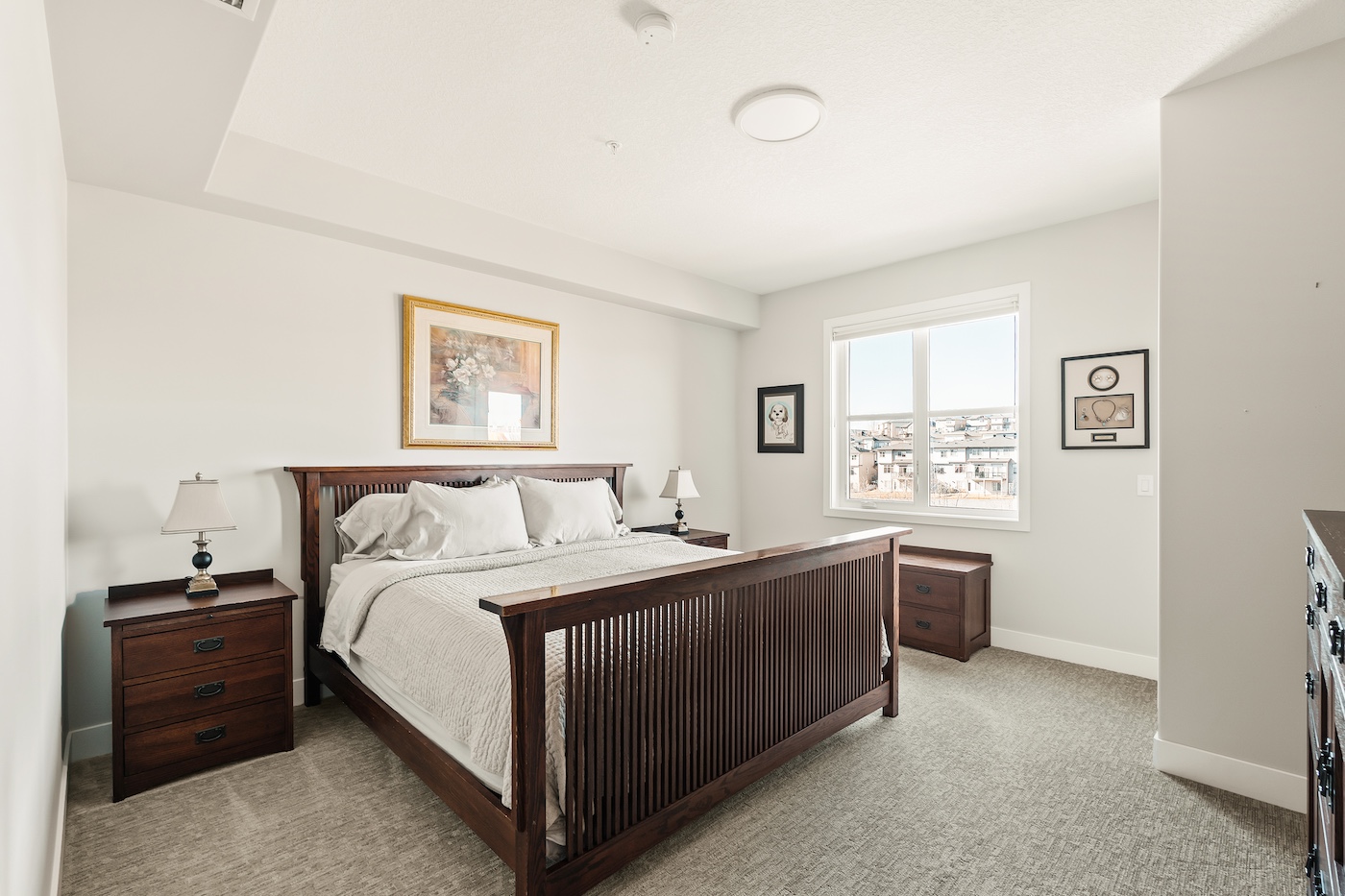 A bedroom with a bed and side tables