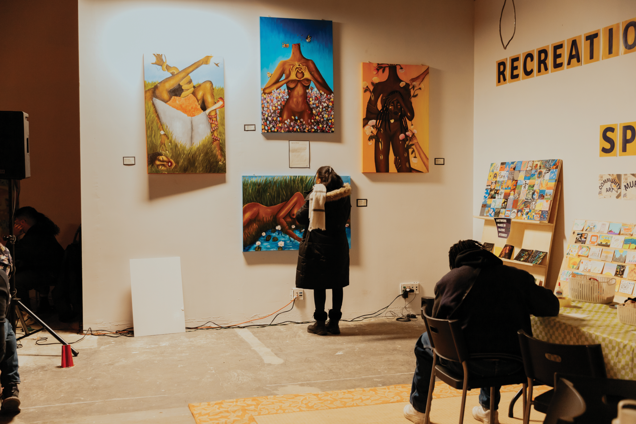 A person views artwork inside a studio space.