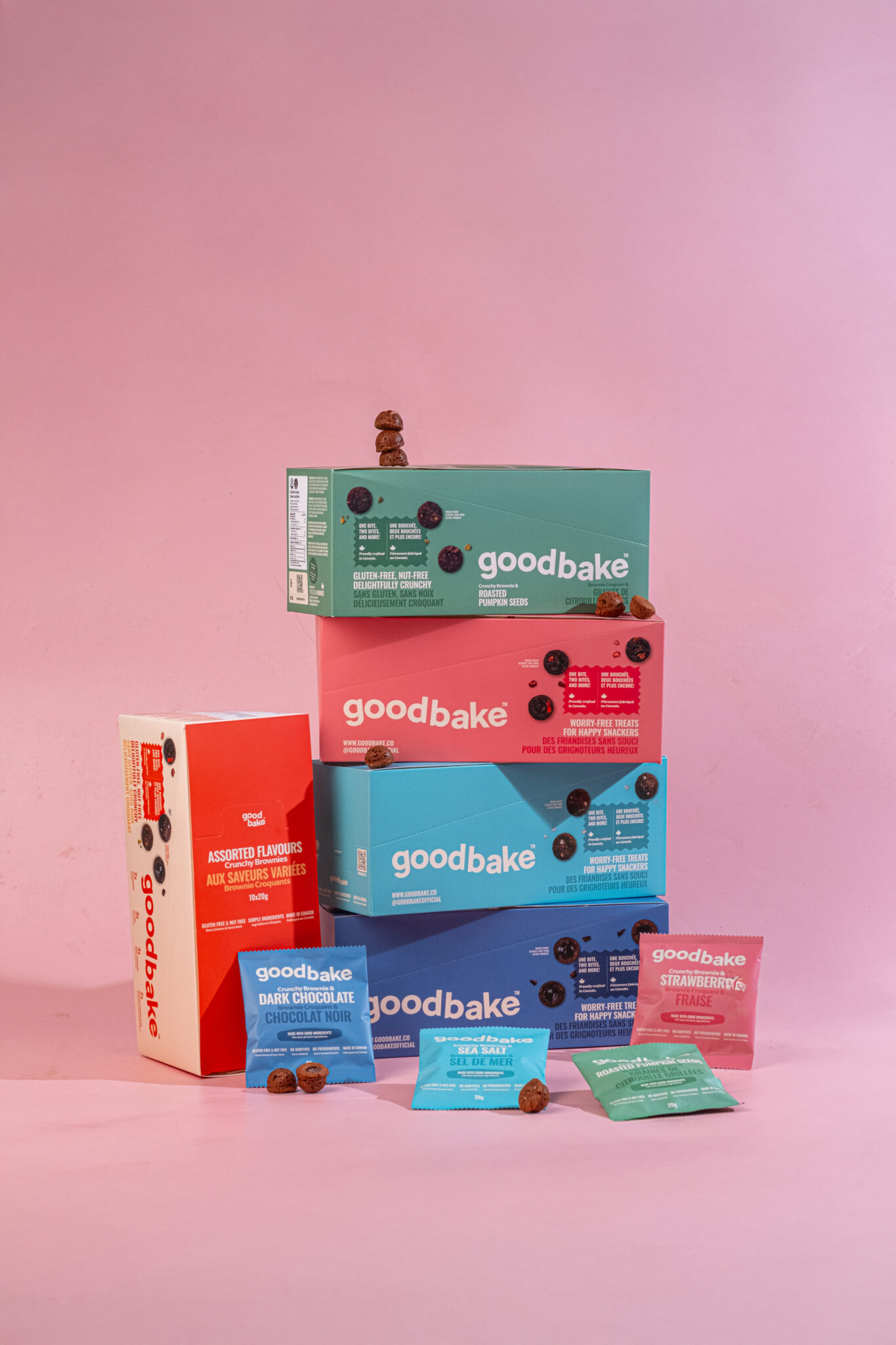 Colourful snack boxes that are stacked on top of each other with small snack packages displayed in front of them.