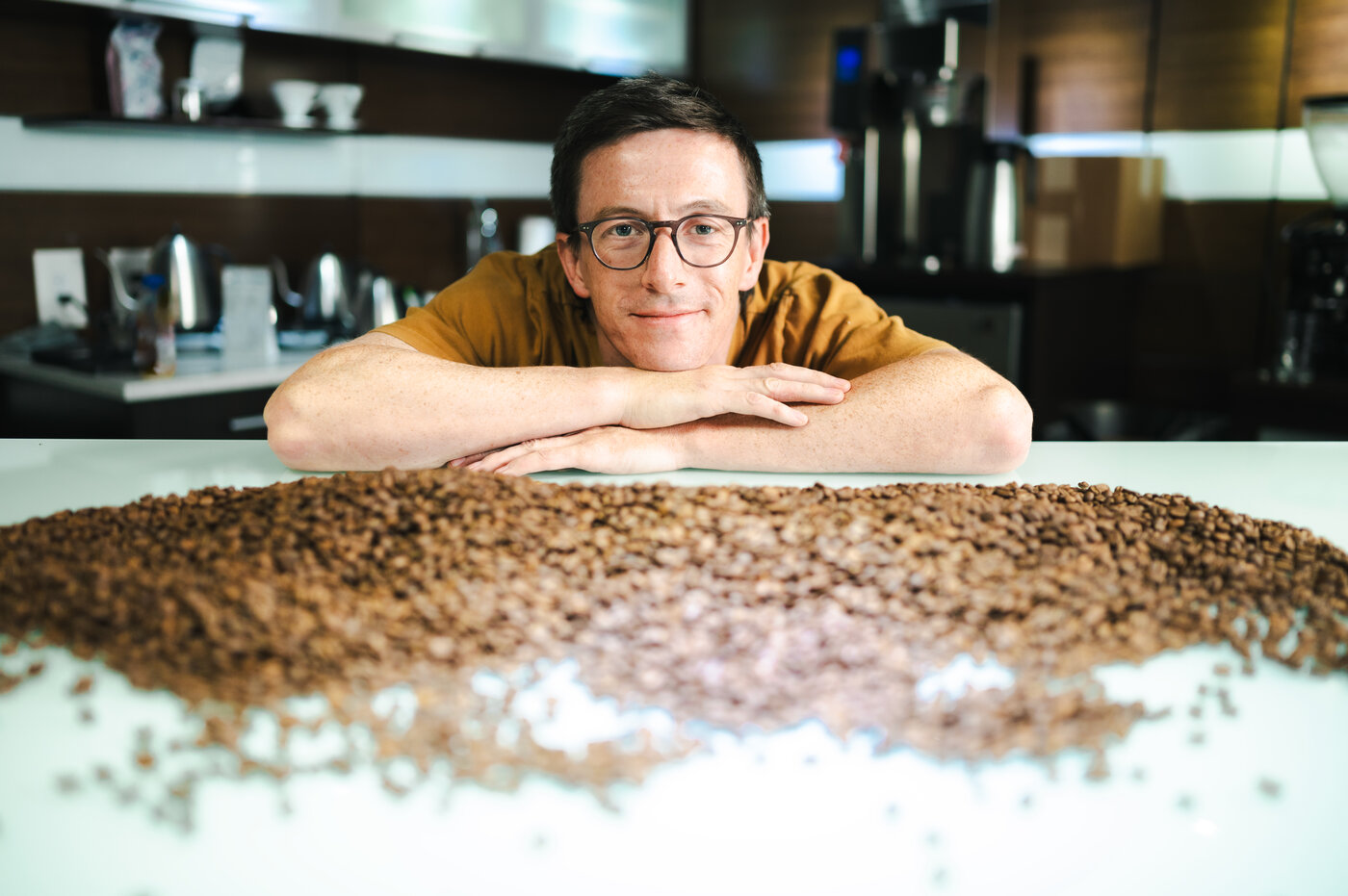 Ben Put rests his head in a pile of coffee.