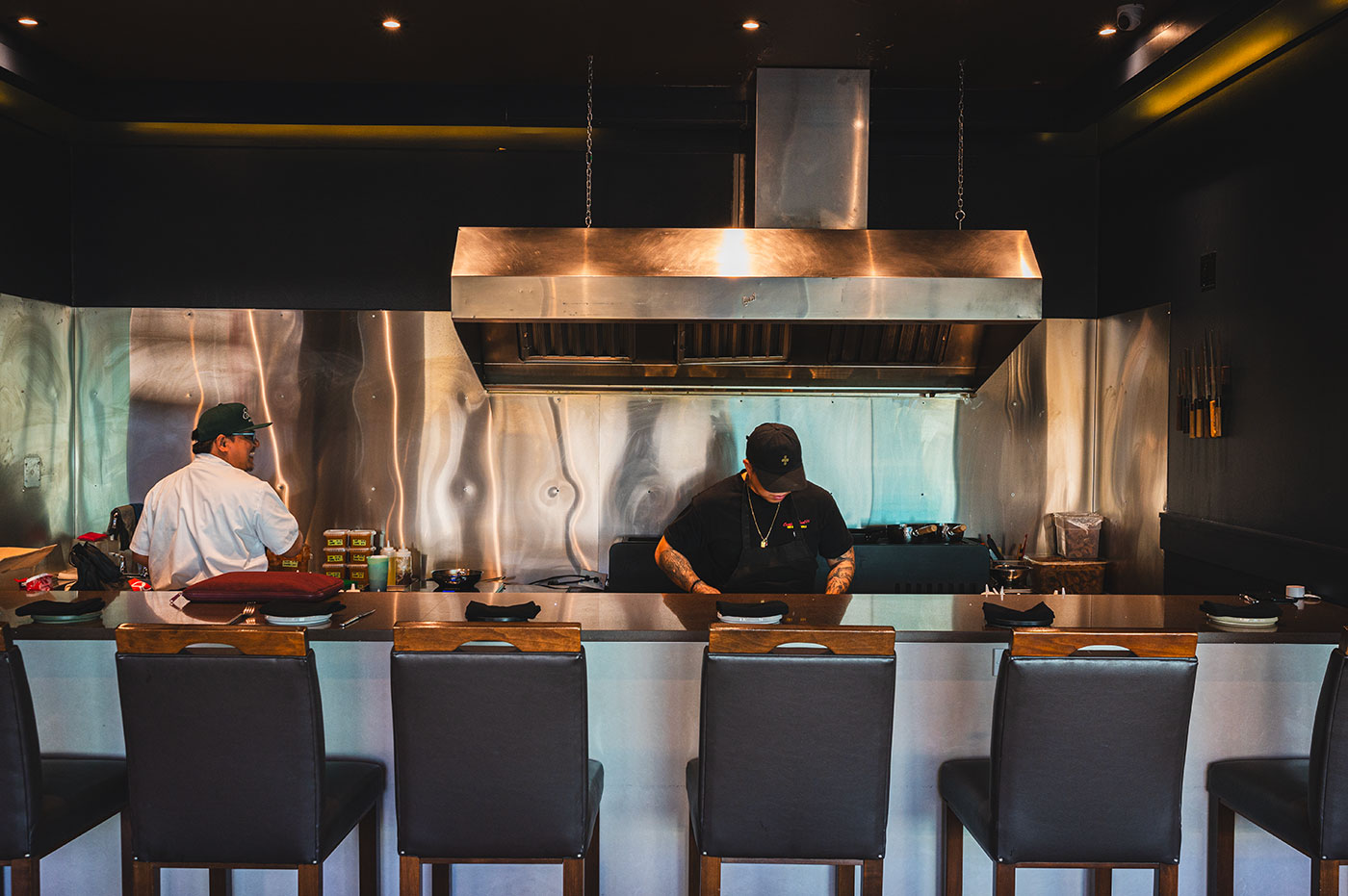 Two chefs work in a kitchen.