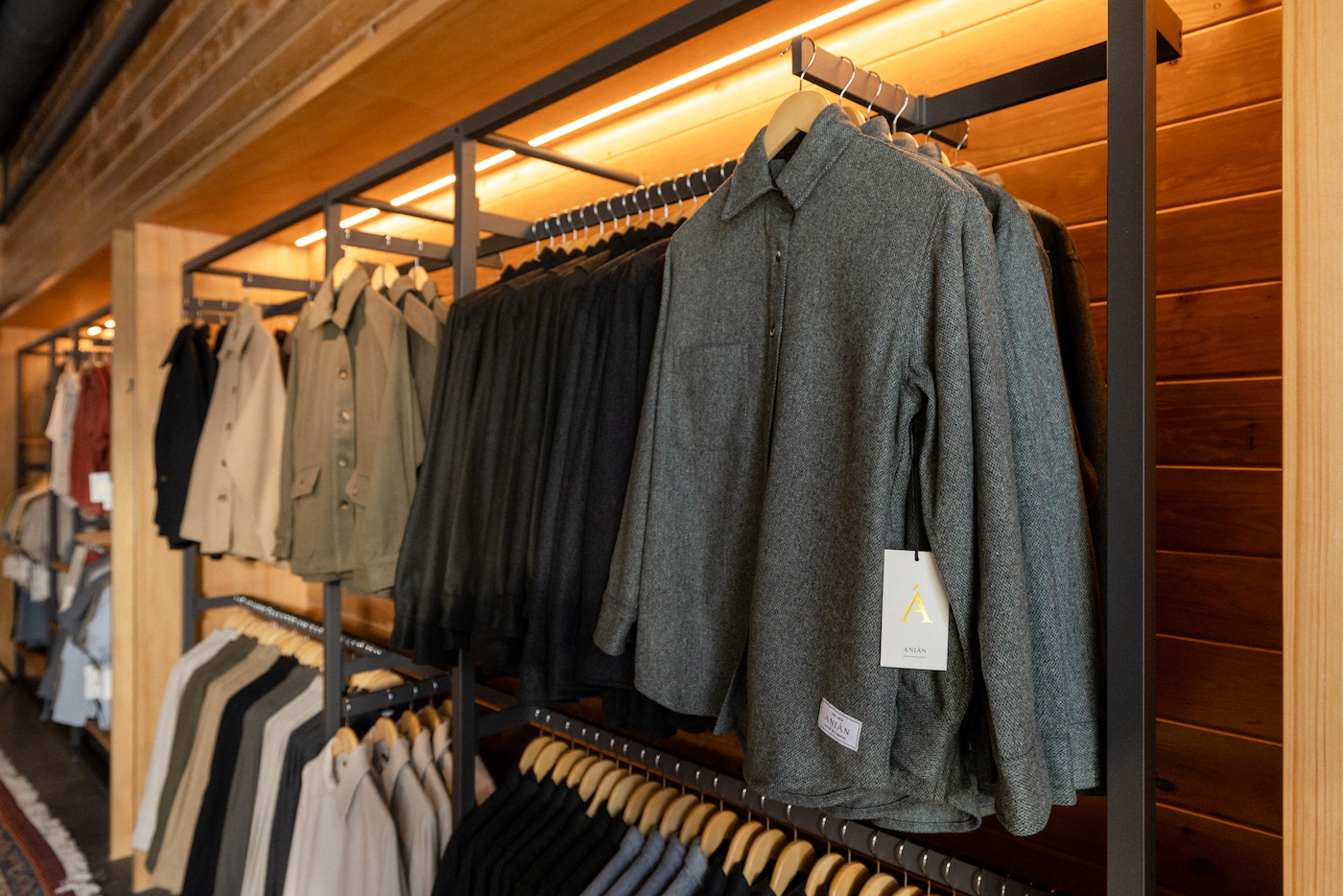 Jackets hanging on a rack against a store wall