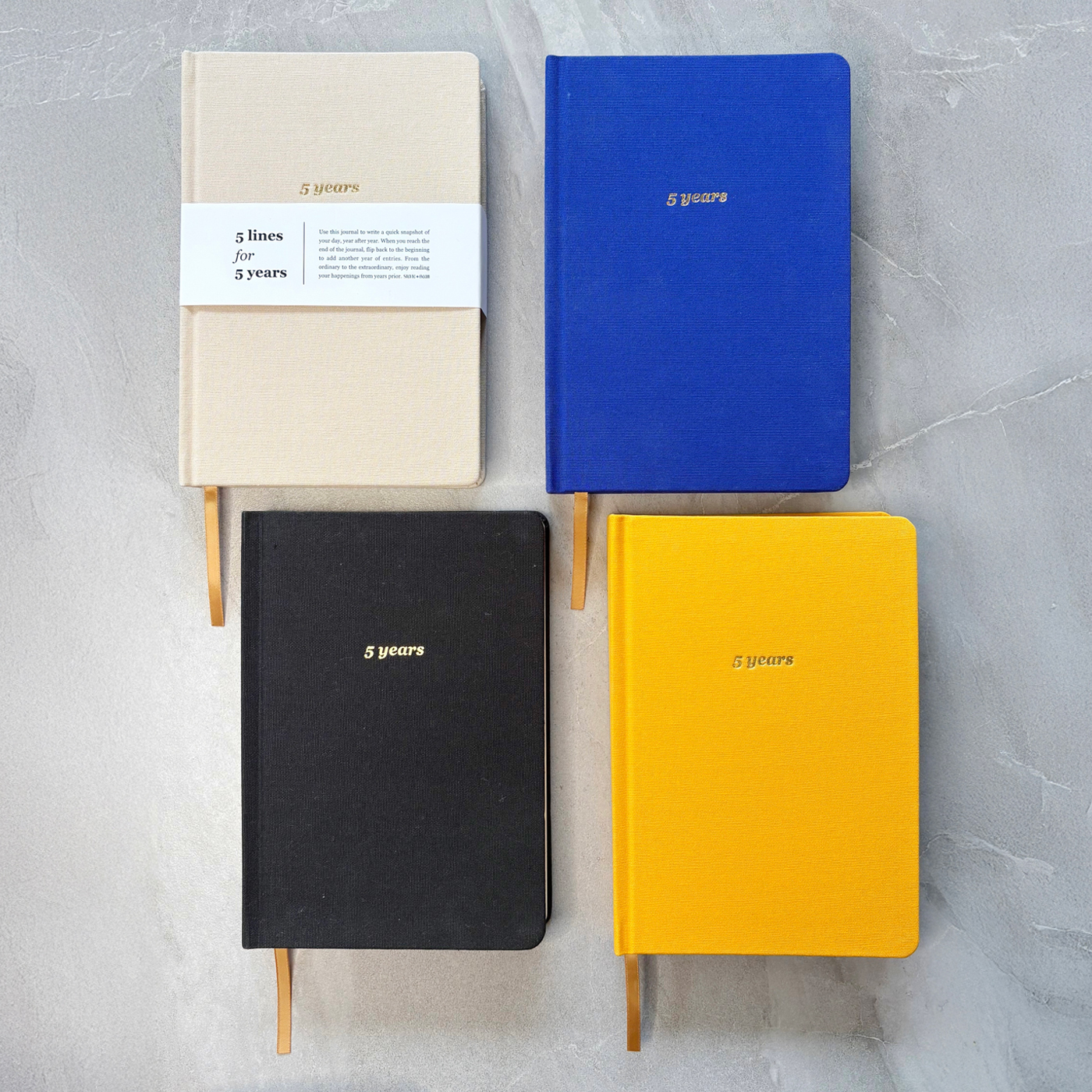 Four journals in different colours