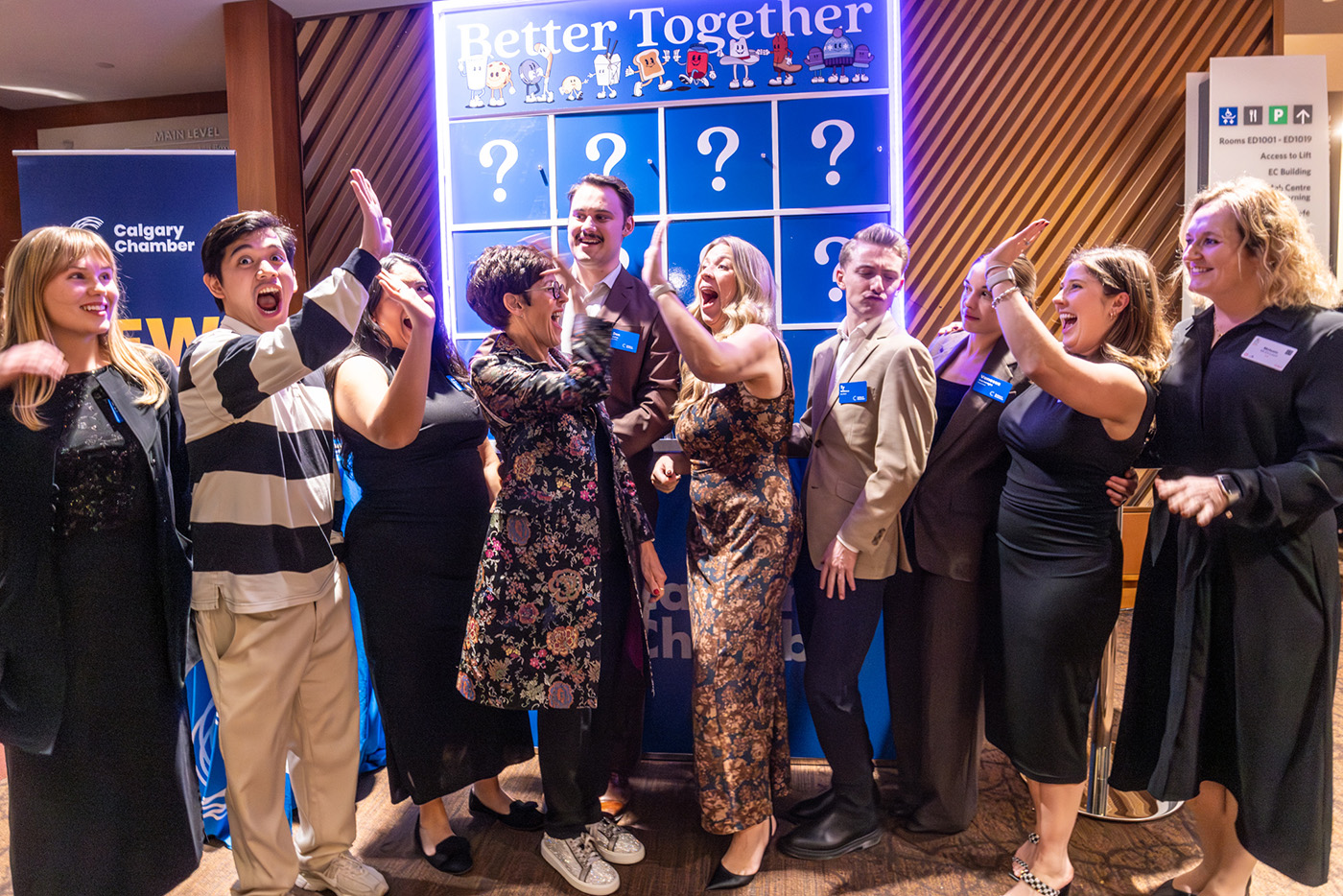 A group of people give each other high fives in front of a game