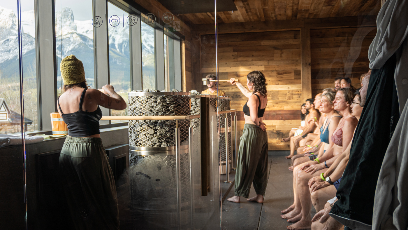 Spa staff members do a guided ritual with guests