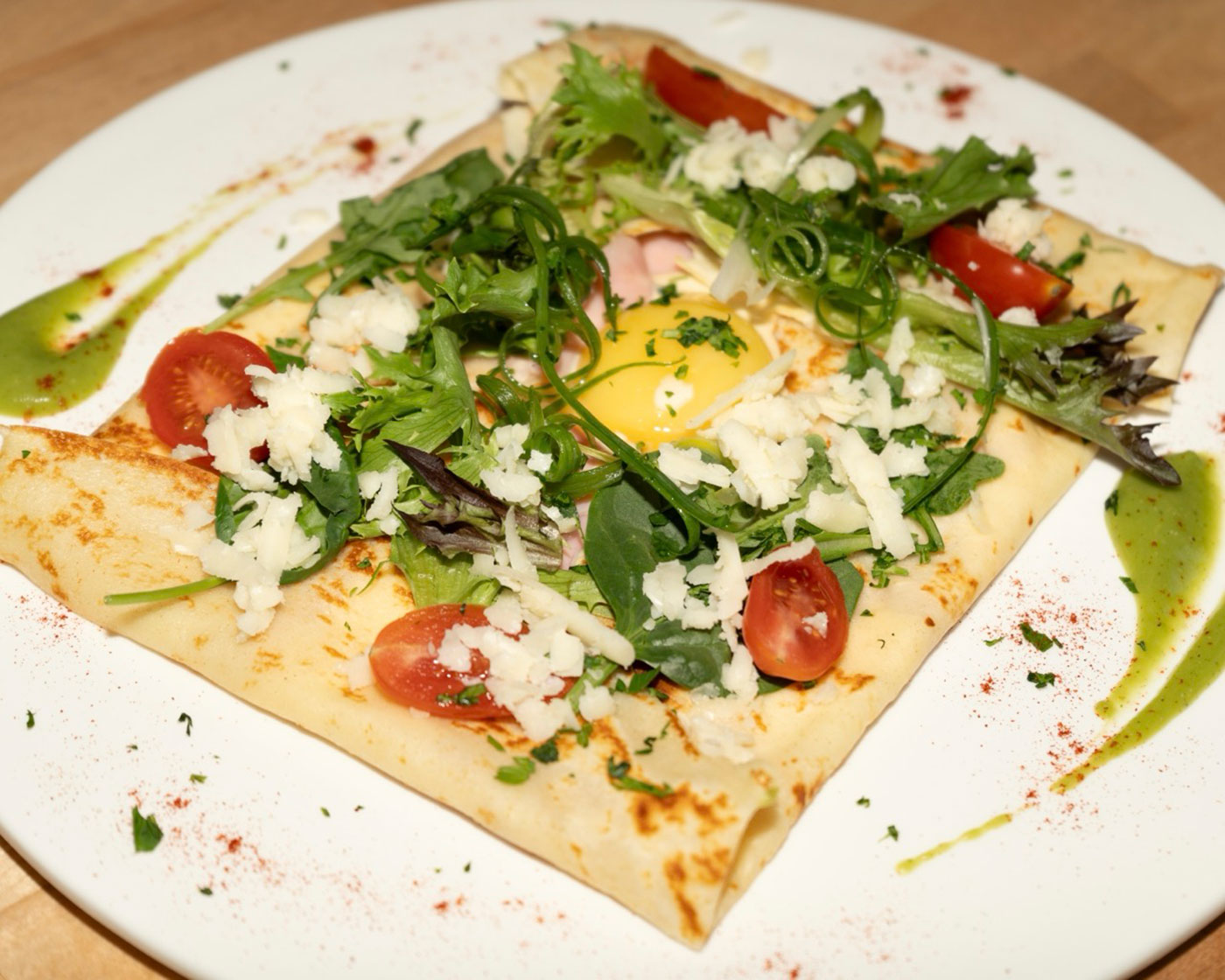 A crepe sits on a plate.