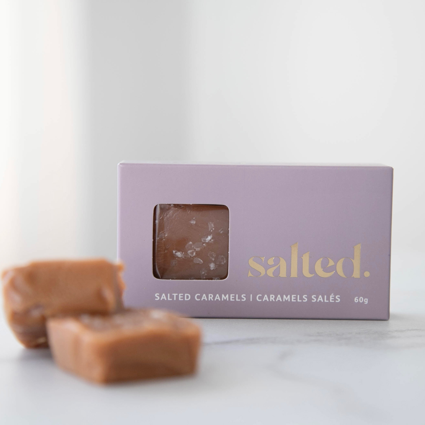 A box of caramels and some caramels on a counter
