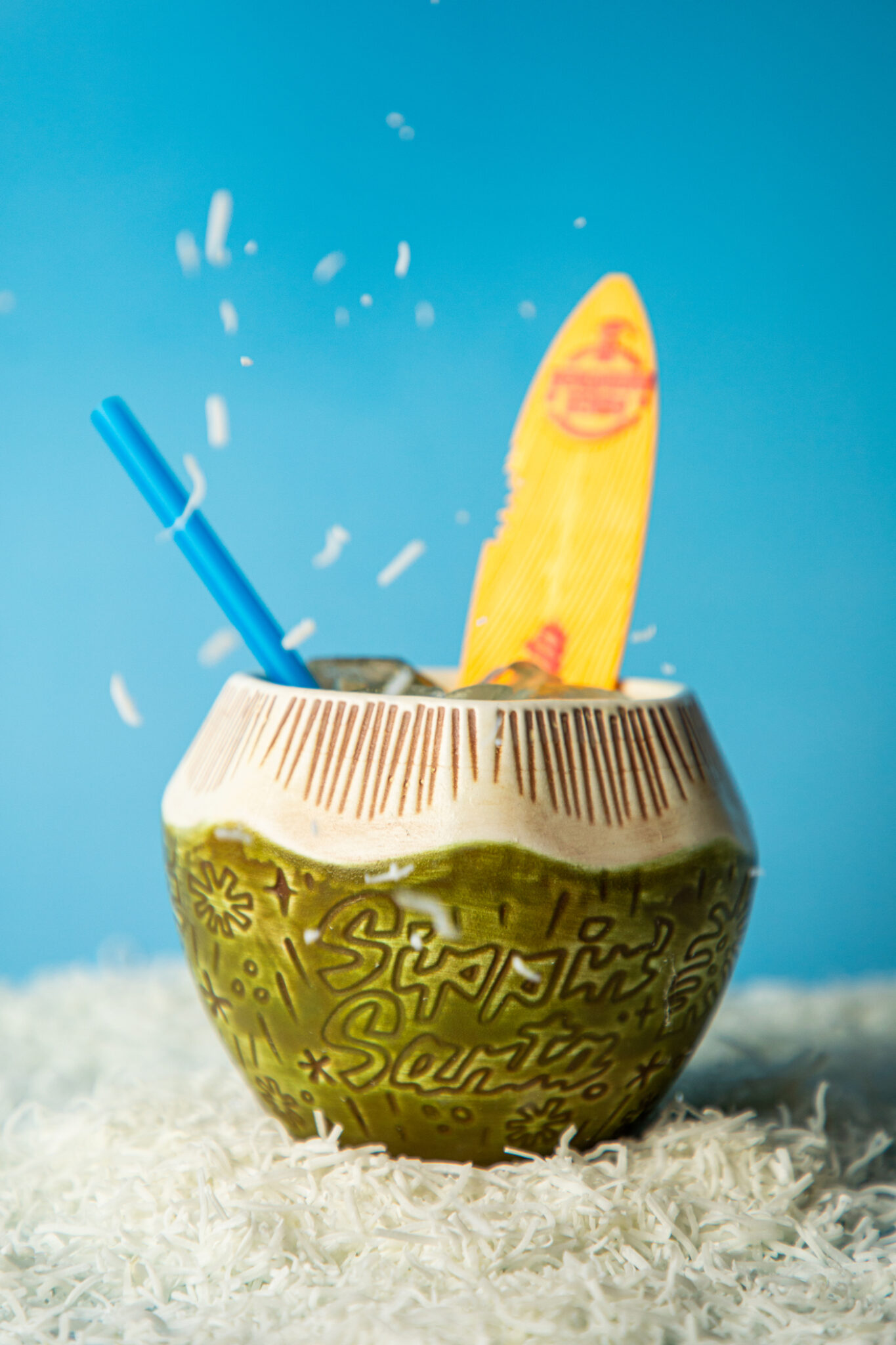 A cocktail served in a cup resembling a coconut