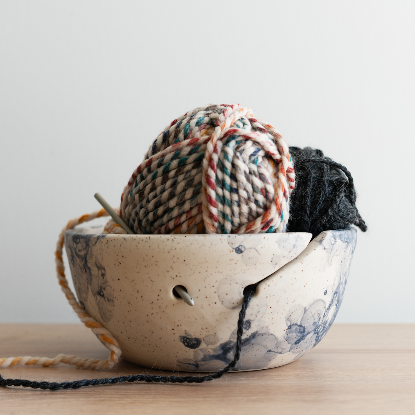 A yarn bowl filled with balls of yarn