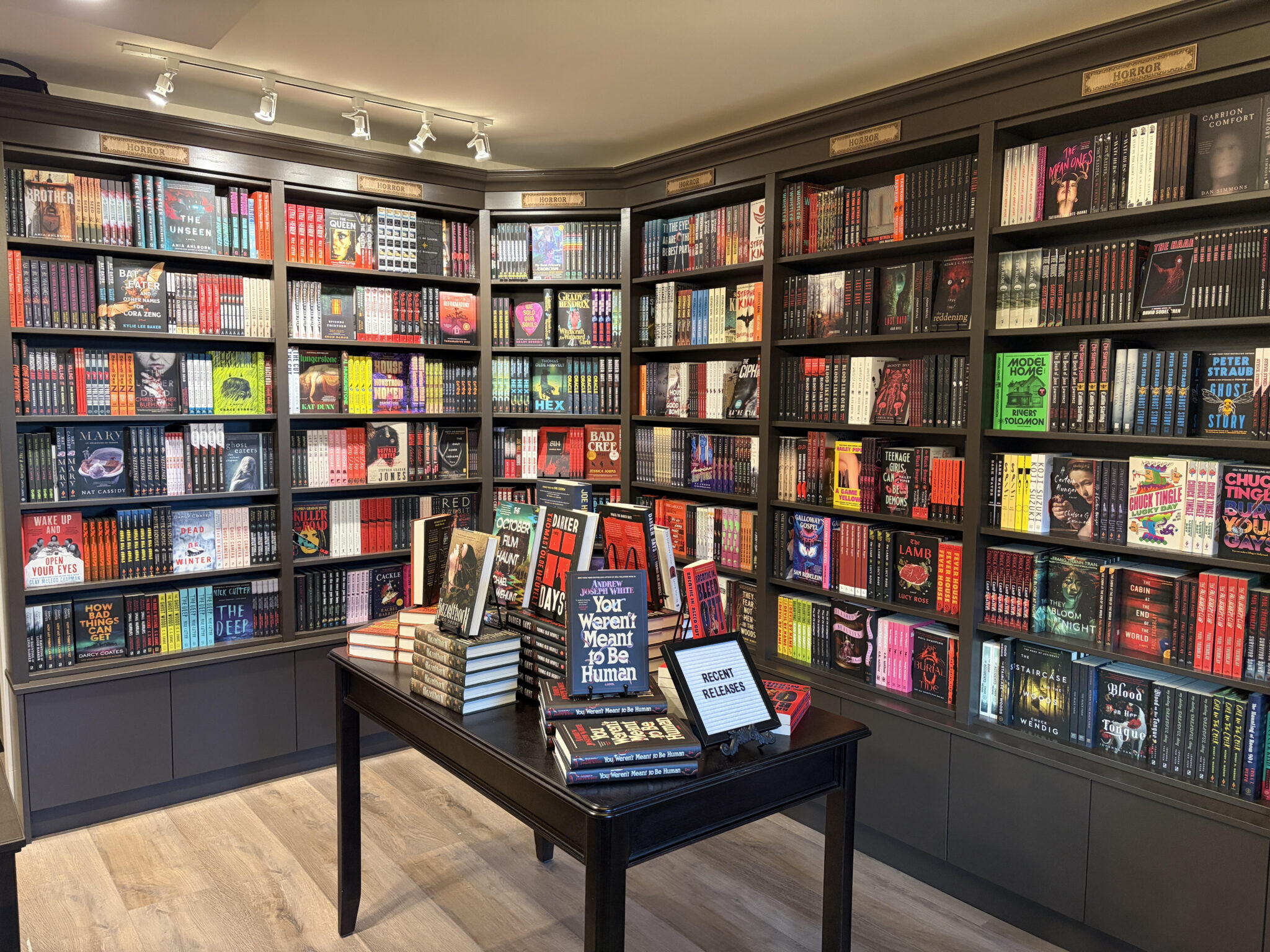 Inside a bookstore with books on shelves and a table