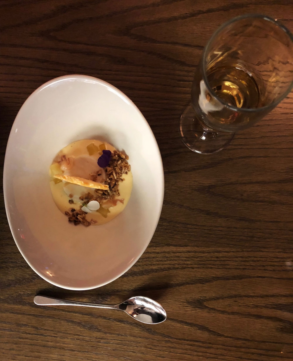 Coconut tapioca pudding with passionfruit créme anglaise, tropical fruit and spriced granola.