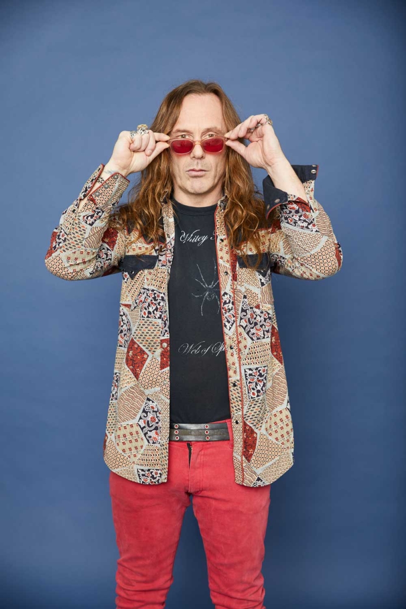 Printed shirt from Kenny Rogers Western Collection; red pants by Serious Clothing; T-shirt, sunglasses, belt and custom-made rings are all his personal collection.