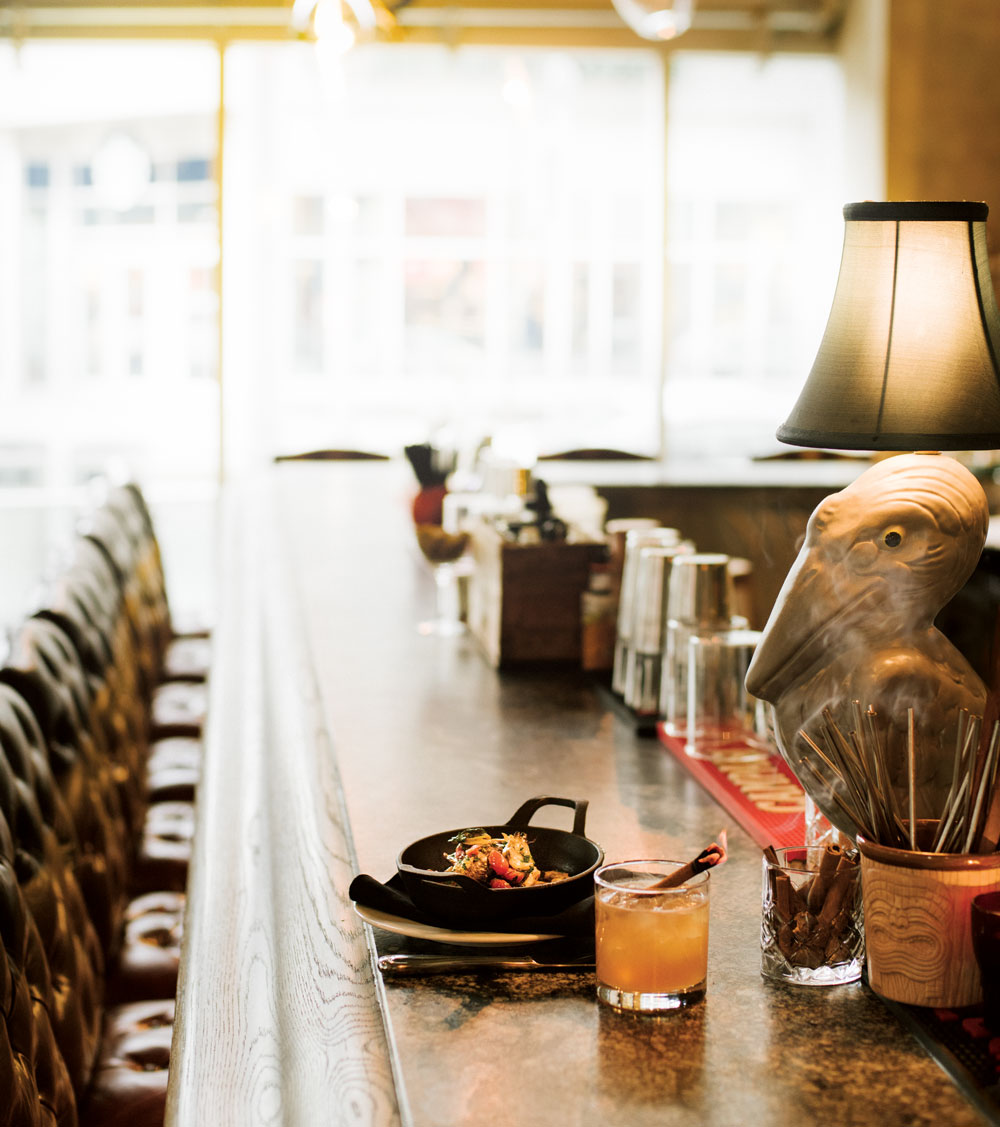 On the bar: Pan-braised smelt fish with sofrito and clam vinaigrette. The Wallace cocktail, with Dillion’s Pear Eau-de-Vie, Writer’s Tears Irish whiskey, Cocchi Americano vermouth, lemon juice, cinnamon simple syrup 
and Angostura Bitters.