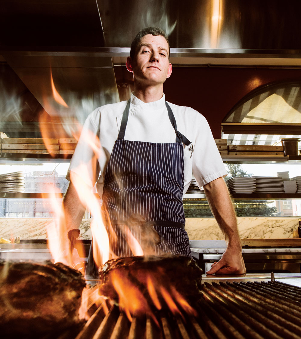 Executive chef Spencer Wheaton grilling a double-cut Fiorentina-style rib steak.