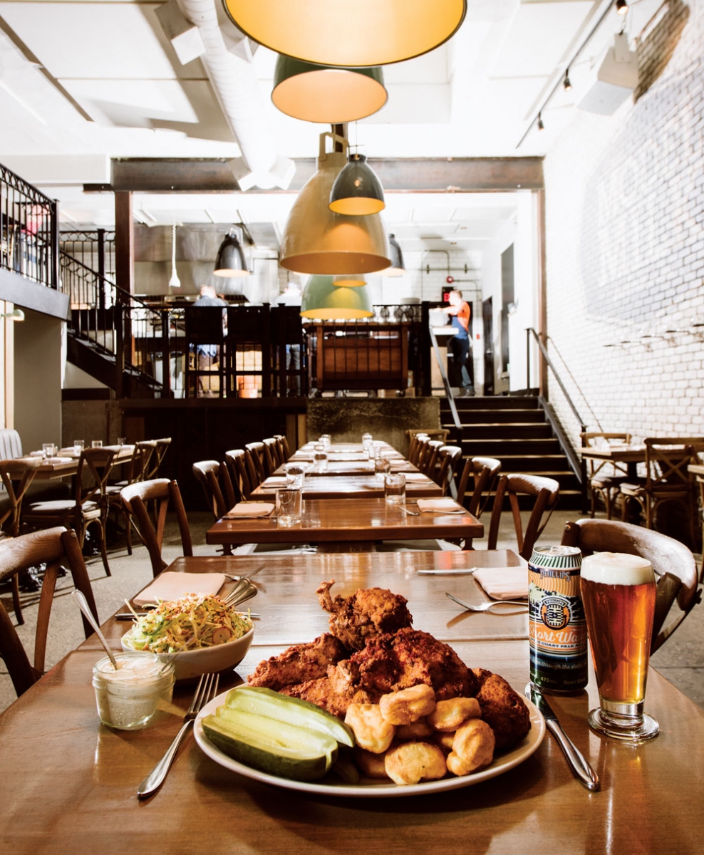 On the table: Nashville hot chicken with buttermilk waffles, peanut coleslaw, dill pickles and crema.