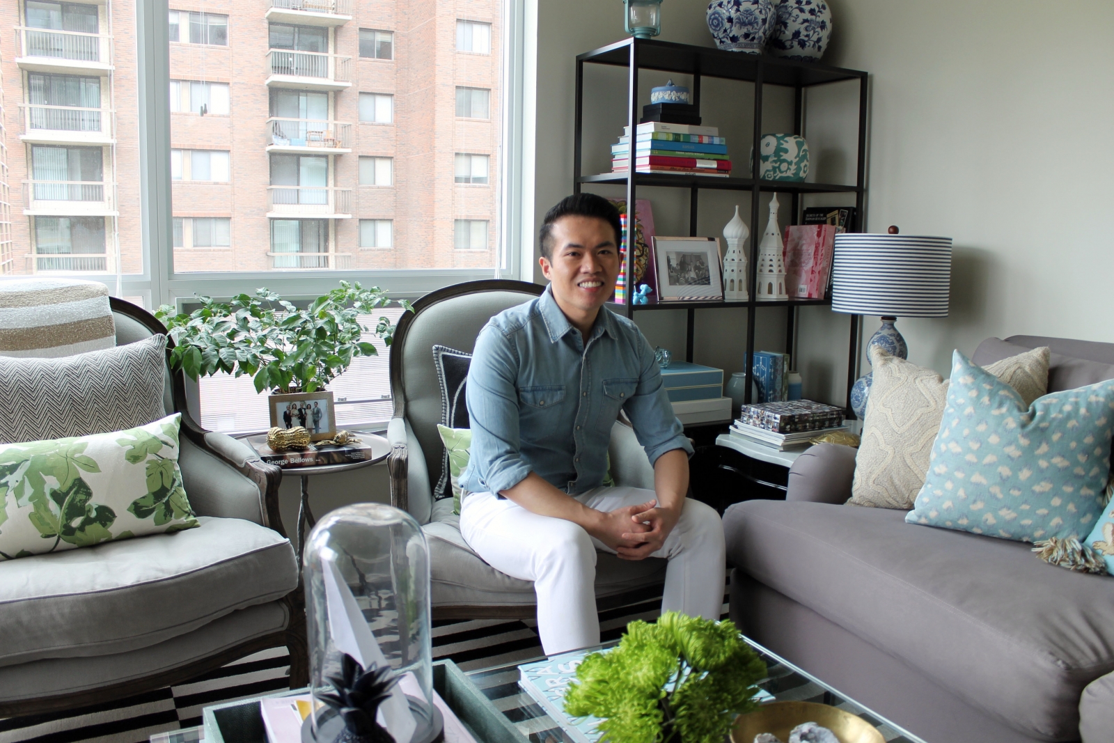 Colin Cheng in his favourite room in his home, the living room, with sprawling views of the Beltline and Lougheed House.