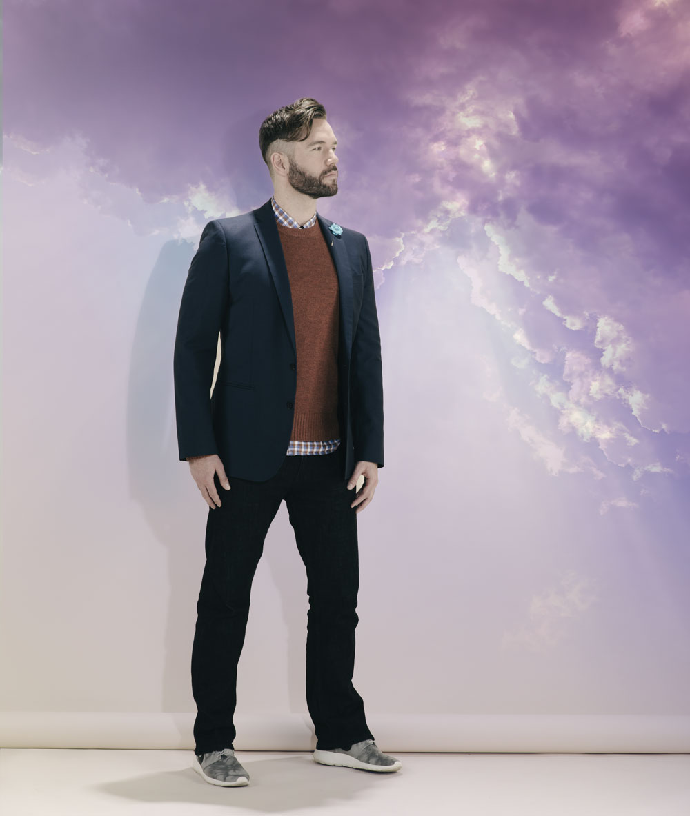 Navy suit by J. Lindeberg; shirt by Selected Homme; sweater from Gap; jeans from Levi’s; Nike runners from LESS17; flower pin from Club Monaco.