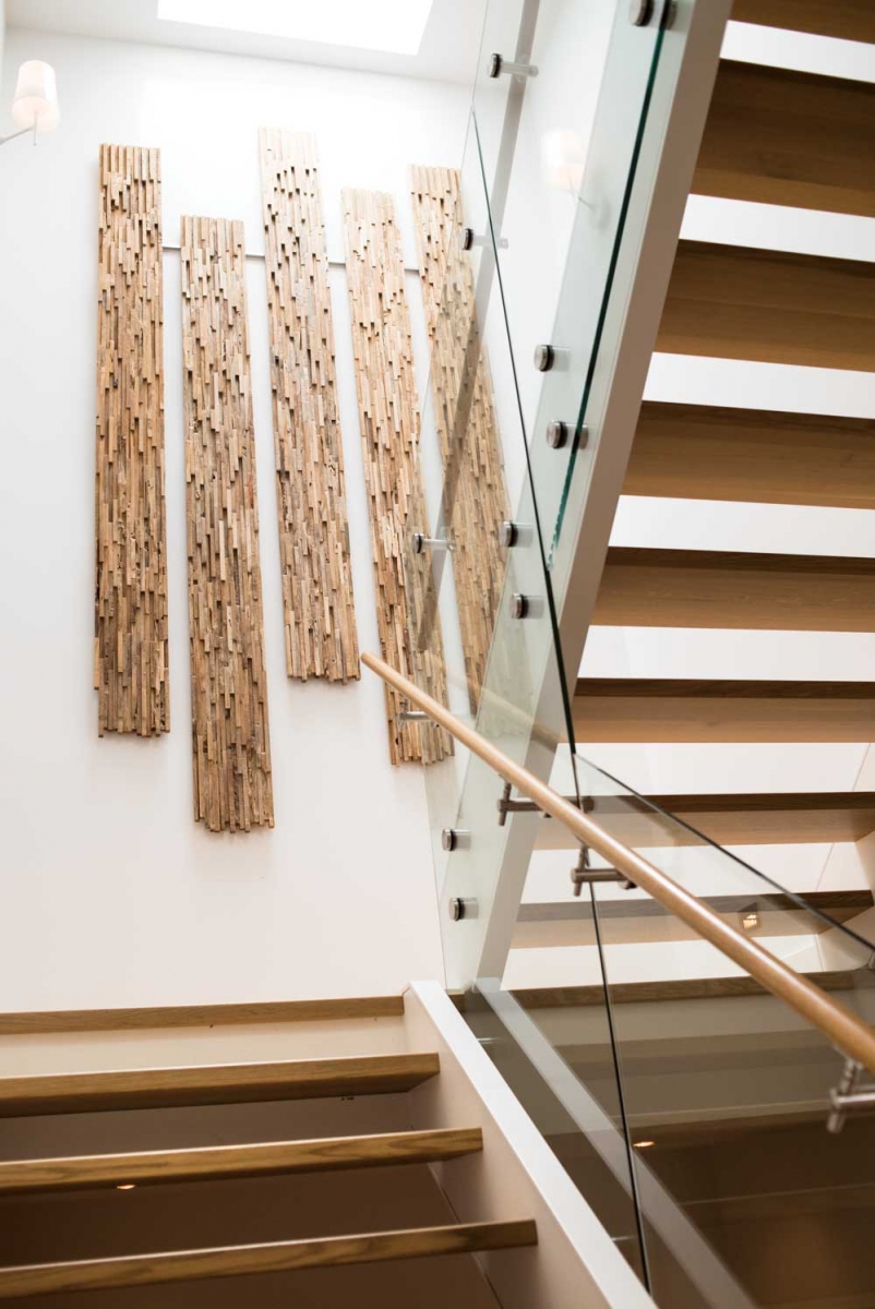 Homeowner and designer Chris Lemke created the staircase art piece out of salvaged wood sourced from Salt Spring Island.