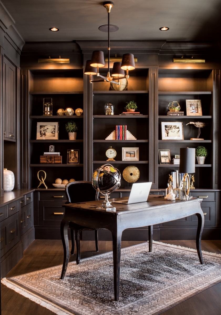 Januszewska’s office features custom-made shelving displaying a curated collection of family photos and treasured mementos. The desk and chair are antiques paired with a new light fixture from Restoration Hardware.