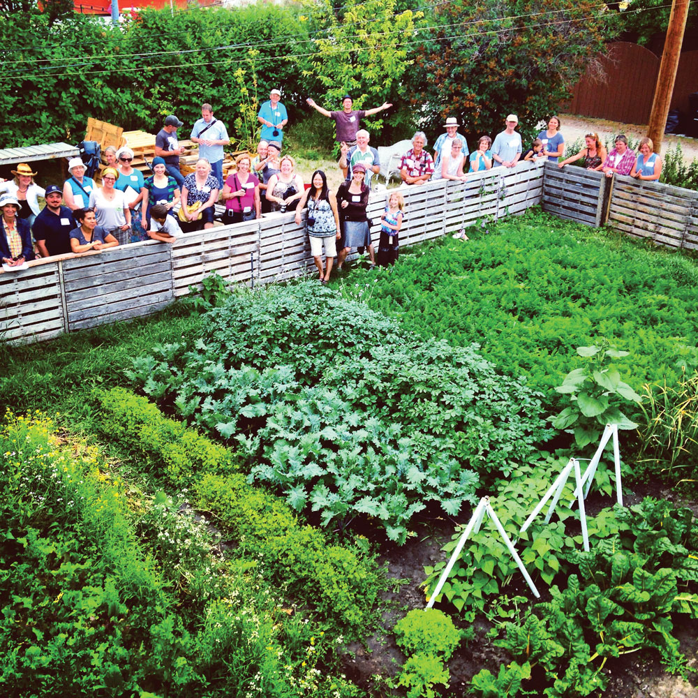 Calgary Permaculture Tour 2014 in Ramsay, with Ted Bahr (shown with arms outstretched) of Prairie Sage Permaculture.