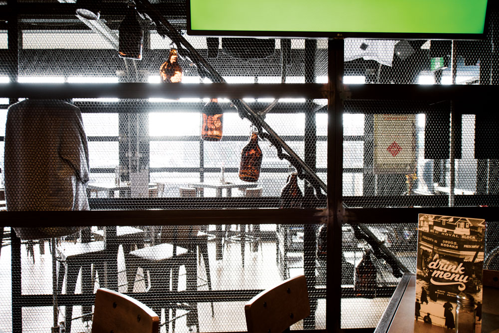 A moving conveyor of growlers makes beer part of the decor at Trolley 5.