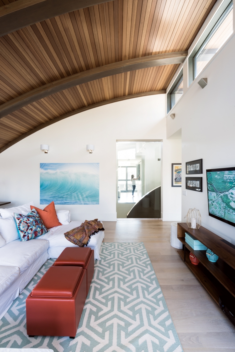 The upstairs family room features a curved timber ceiling made of Douglas fir glulam and Kayu Batu wood.