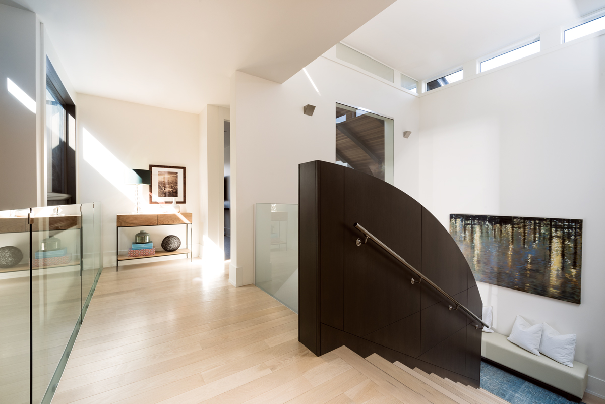 The Armstrong home is full of shapes that are reflective of the architecture, including the curved wall of the staircase leading up to the family room.