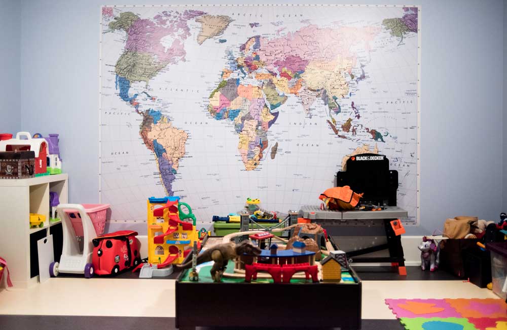 In the basement, the wall colour of the children's playroom was purposefully chosen to match the colour of the ocean on the map.