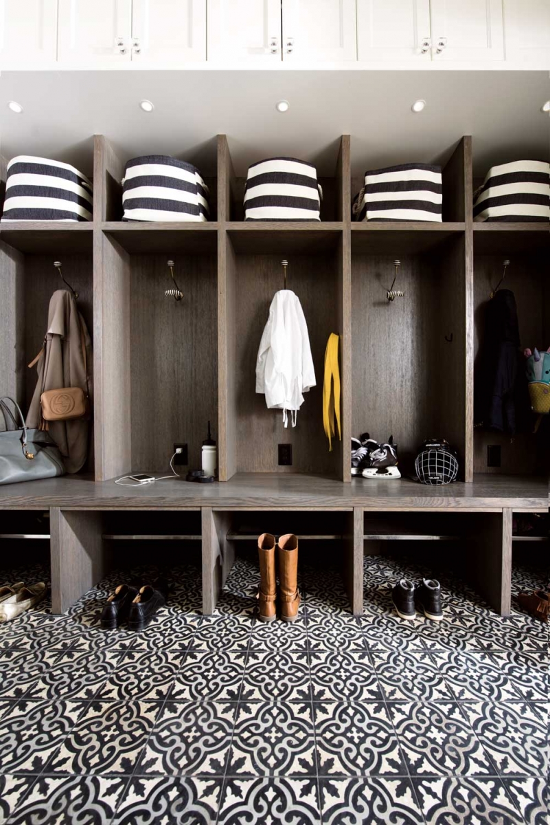The mud room has custom-built lockers for each family member and bold-patterned tile chosen for the demands of a high-use area.