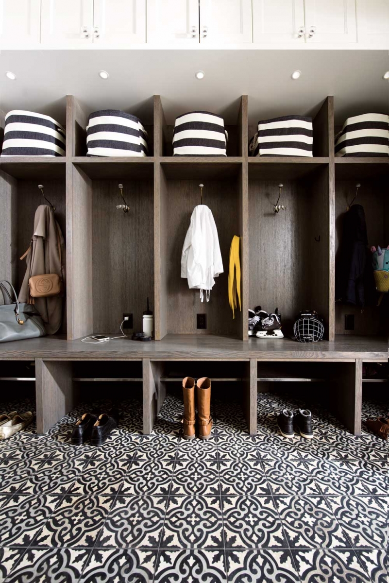 The mud room has custom-built lockers for each family member and bold-patterned tile chosen for the demands of a high-use area. 