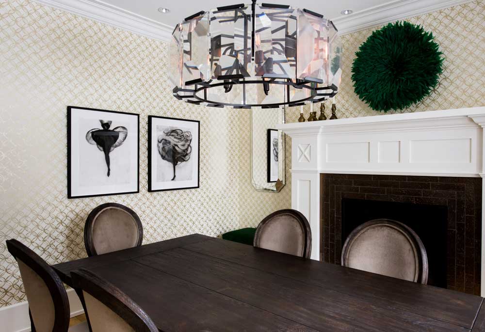 The family's formal dining room also features black and white artwork by Cathy Daley, as well as a piece of artwork bought off Etsy over the fireplace.