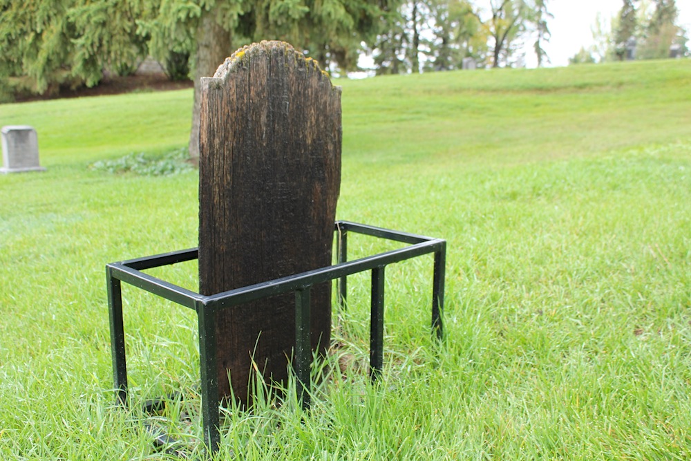 This wooden grave is one of only two in the cemetery. It belongs to John Sibley, a 10-year-old who's family could not afford the more expensive stones for a memorial. Etched onto the Douglas Fir is the the date of the boy's death, December 29, 1909. The grate around it was put in place after the City noticed its weed wackers and lawn mowers had inadvertently been chipping away at the base of the grave.